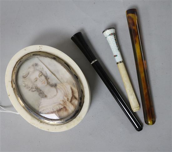 An ivory snuff box and three cheroot holders